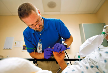Mike Emerson RN checks a patients blood sugar at Fort Defiance Indian Hospital. — © 2009 Gallup Independent / Brian Leddy 