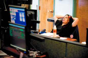 Vandee Campos takes a breather during a busy period at McKinley County Metro Dispatch on Friday, May 2. — © 2009 Gallup Independent / Brian Leddy 
