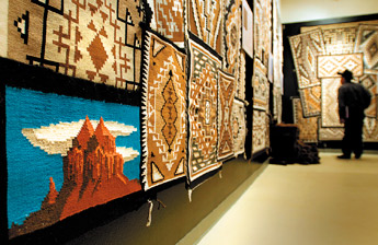 The colorful corner section of a rug from the Asdzáá Bit' Ahnii family is one of many unique designs on exhibit at the Navajo Nation Museum WIndow Rock. — © 2009 Gallup Independent / Adron Gardner