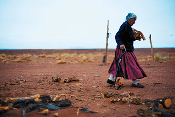 Katharine Peshlakai gathers wood at her home in Black Falls, Ariz. Peshlakai was one of the last four families to be forced from Wupatki National Monument to the Black Falls area. — © 2009 Gallup Independent / Brian Leddy 