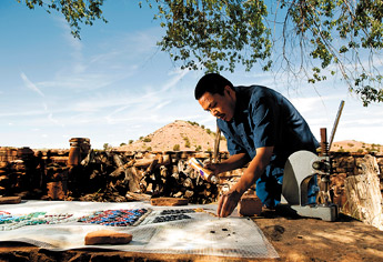 Philander Begay works on a yei bi cheii mosaic at Hubbell Trading Post on Thursday. Begay is learning a new technique from artist in residence Robin Brailsford that he hopes to combine with his native art. — © 2009 Gallup Independent / Brian Leddy
