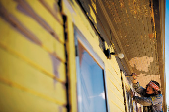 Wyatt McBeth Paints window sills at a house in Gamerco on Monday afternoon. McBeth and several other youth from across the country are in town this week helping repair the home as part of the World Changers organization. — © 2009 Gallup Independent / Brian Leddy