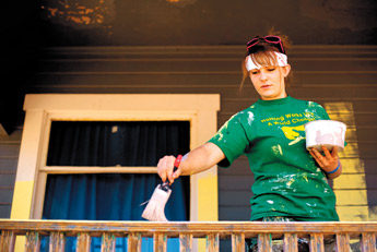 Ally Callahan of Colorado Springs, Colo. paints a railing at a house in Gamerco on Monday afternoon. Callahan and several other youth from across the country are in town this week helping repair the home as part of the World Changers organization. — © 2009 Gallup Independent / Brian Leddy 