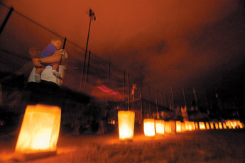Those who lost the battle with cancer are remembered by family, friends and cancer survivors in the Silent Lap, a walk in darkness lit only by luminarias at the Gallup Sports Complex on Friday. The Silent Lap, a purse auction and other festivities were all part of the 2009 Relay for Life in Gallup. — © 2009 Gallup Independent / Adron Gardner 