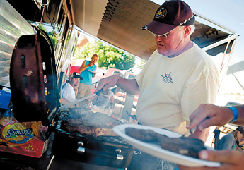 Dave McLaughlin of Montana cooks huge steaks on the grill on Monday. Thousands of junior high rodeo contestants descended upon Gallup this week for the Wrangler Junior High Rodeo. — © 2009 Gallup Independent / Brian Leddy 