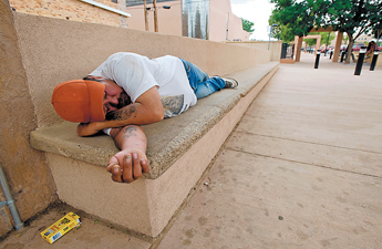 Richard Bitsie takes a nap in the downtown walkway on Wednesday. Bitsie, who admitted to drinking that afternoon, was later taken to Na'nihzhoozhi Center Inc. — © 2009 Gallup Independent / Brian Leddy 