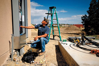 Cornelius Slim of Armored Electric works on the electricity at Lighthouse International Ministries Church on Monday morning. The church, which is under construction, was tagged by vandals this weekend. — © 2009 Gallup Independent / Brian Leddy