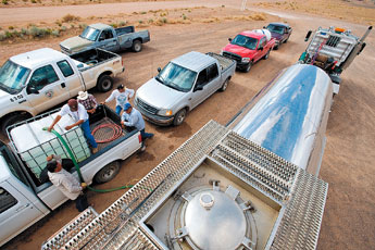 Area residents line up to get water from a Navajo Tribal Utility Authoriy water tanker in Dilkon Tuesday. The Navajo Nation Department of Emergency Management sent tankers throughout the region to help relieve a water shortage. — © 2009 Gallup Independent / Cable Hoover 