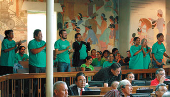 Supporters of the Navajo Green Economy Comission Act, wearing "Green Jobs" t-shirts, cheer Tuesday afternoon as the Navajo Nation Council passes the legislation, 62-1 — © 2009 Gallup Independent / Kathy Helms