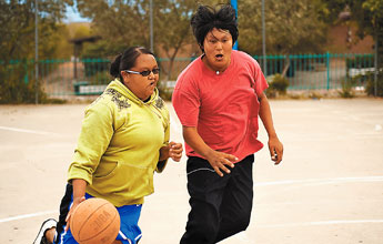 It's a hair raiser for Kendrick Tsosie, right, as Shantell Begay, left, goes for a drive in a game of hoops at Ford Canyon Park on Tuesday. — © 2009 Gallup Independent / Adron Gardner