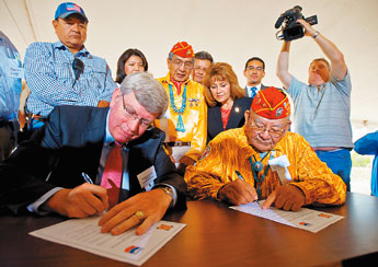 Chevron Mining Company President Frederick Nelson and Navajo Code Talker Keith Little sign a land transfer deed on Friday east of Window Rock. Chevron transferred over 200 acres of land to the Code Talker Association to build a museum. — © 2009 Gallup Independent / Brian Leddy 