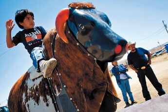 Daniel Mailman Jr. waits for the machine to start as he takes a turn on the mechanical bull at the Eastern Navajo Fair in Crownpoint Saturday. — © 2009 Gallup Independent / Cable Hoover 