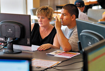 Linda Blanco and her son Brice, 18, look over the electronic course catalogue in the Registration office at UNM-G on Wednesday. Brice wants to major in Education, a department where his sister is also a student. — © 2009 Gallup Independent / Brian Leddy 