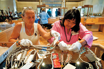 Jill Pulgar and Laveda Buser sort jewelry entries to be put into cases after judging had been completed for the Gallup Inter-Tribal Ceremonial juried Art Show on Monday afternoon. State senators and representatives were in town to took a tour of entries in the Gallup Inter-Tribal Ceremonial Art Show.— © 2009 Gallup Independent / Brian Leddy 
