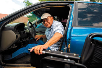 Roger Plummer gets into his vehicle after leaving his volunteer position at the San Juan Center for Independence on Tuesday afternoon. With help from the Department of Vocational Rehabilitation, Plummer has been able become more independent. The state agency graded and graveled his driveway this year to make it easier for him to get from his car to his home. — © 2009 Gallup Independent / Brian Leddy