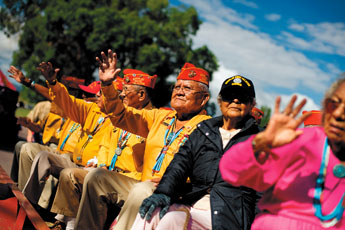 Guy Clauschee and several other Navajo Code Talkers wave at passerby during a parade honoring their achievements on Friday morning. — © 2009 Gallup Independent / Brian Leddy