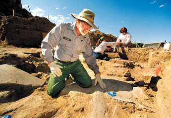 Park archaeologist Roger Moore points out some of the excavated area of a recently discovered pit house at Chaco Culture National Historical Park on Tuesday. Moore believes the uncovered area dates to around 500 B.C.. Carbon dating from corn recovered in the fire pit will confirm the actual age of the discovery. — © 2009 Gallup Independent / Adron Gardner 
