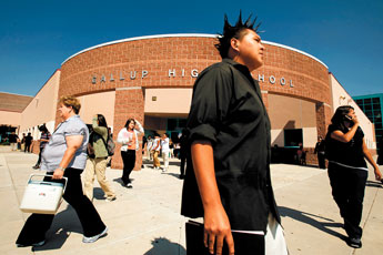 Students and staff at Gallup High School exit the building after the first day of school on Monday. This year the McKinley County School district has implemented a cell phone ban this year on school premises during school hours. — © 2009 Gallup Independent / Adron Gardner