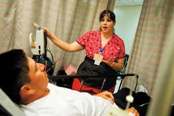 Cibola General Hospital nurse Amber Van Camp checks with Rigoberto Alvardo in the emergency room Aug. 5. The hospital is celebrating its 50th anniversary this year. — © 2009 Gallup Independent / Brian Leddy 