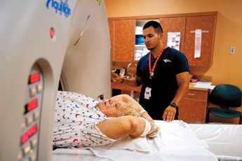 Geraldine Damron prepares to be scanned by Radiology Technician student Isaac Atencio at Cibola General Hospital. The hospital is celebrating its 50th anniversary this year.— © 2009 Gallup Independent / Brian Leddy 