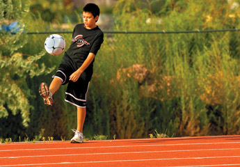 Keaton Duncan kicks a stray soccer ball from the fences at Grants High School on Tuesday. — © 2009 Gallup Independent / Adron Gardner 