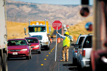 A construction worker flags vehicles on Highway 491 south of Tohatchi on Thursday morning. Traffic remains congested as construction has narrowed the highway down to one lane in one section. — © 2009 Gallup Independent / Brian Leddy 