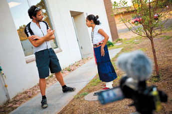 Cyclist and documentarian Mark Beaumont, left, talks with Melosa Padilla about her traditional attire in Sanders, Ariz. Thursday. Beaumont spent the night in Sanders while in the process of riding his bike across the Americas and filming the trip for a documentary. — © 2009 Gallup Independent / Cable Hoover 