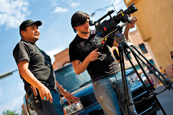 Filmmaker Norman Patrick Brown, left, watches over the shoulder of his cameraman Vincent Pascoe as they film Brown's movie "Rainbow Boy" in downtown Gallup Sunday. — © 2009 Gallup Independent / Cable Hoover