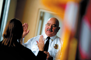Gallup Fire Chief Robert Soto is sworn in by Judge Linda Gasparich-Padilla on Friday at the south side fire station. Thirty-one firefighters were sworn in. — © 2009 Gallup Independent / Brian Leddy