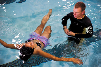 Julieta Espino practices floating on her back with scuba instructor Brian Kinley during the Police Atheletic League's scuba training at the Gallup Aquatic Center Saturday. — © 2009 Gallup Independent / Cable Hoover