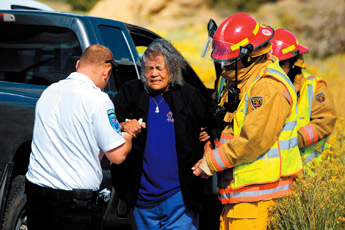 Nellie Lee is escorted by Gallup Fire Department officials at the scene of an accident at the intersection of N.M. Highway 602 and Nizhoni Boulevard in Gallup on Wednesday. The Dodge Dakota Lee was riding in allegedly pulled out into traffic and struck a Chevy Tahoe traveling north on Highway 602. No serious injuries were reported and Lee was transported to the hospital. — © 2009 Gallup Independent / Brian Leddy 