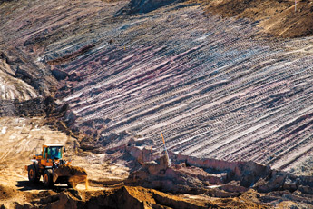 Earth moving equipment move soil from an unnamed arroyo at United Nuclear Corporation's old mine site north of Churchrock on Thursday morning. — © 2009 Gallup Independent / Brian Leddy 