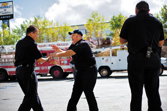 Fire fighters Mike Gleason, left, and Dominick Riffle joke and laugh with each other outside the south side fire station Wednesday. — © 2009 Gallup Independent / Cable Hoover