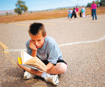 Fifth-grader Kenneth Nunes catches up on reading during recess at Bluewater Elementary School on Tuesday. Administrators say that small class size and one-on-one interaction with students helped them make Adequate Yearly Progress for the past five years. — © 2009 Gallup Independent / Brian Leddy