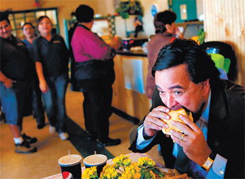 Gov. Bill Richardson takes a giant bite out of a giant burger at Badlands Burgers in Grants on Friday. Richardson was in town for the Cibola County National Day of Remembrance. — © 2009 Gallup Independent / Brian Leddy 