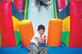 Marcel Valda laughs as he emerges from one of the inflatable apparatus at the new children’s play area owned by his father, Eduardo Valda on Oct. 8. — © 2009 Gallup Independent / Cable Hoover 