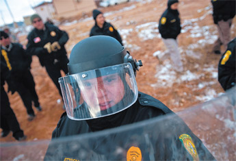 Navajo Police Senior Officer Irvin Attson runs drills with other members of the Navajo Police Department during the department’s riot control training in Window Rock Thursday. The department started the training in response to recent troubles in the Navajo tribal government. — © 2009 Gallup Independent / Cable Hoover