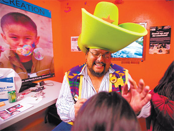 Lions Club volunteer Stanley Van Keuren Jr. paints children’s faces during the Zoo Boo Halloween event at the Navajo Nation Zoo Friday. — © 2009 Gallup Independent / Cable Hoover