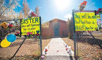 A makeshift shrine for Sister Marguerite Bartz hangs on the fence around the Saint Berard Mission Church in Navajo, N.M., Wednesday. — © 2009 Gallup Independent / Cable Hoover 