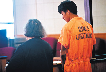 Reehahlio Carroll, left, stands with public defender Rosie Cortez during his arraignment in Window Rock Friday. — © 2009 Gallup Independent / Cable Hoover 