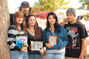 From left, Little Bear’s mother, Lori Fowler, stepfather Mike Fowler, sisters Candace Jeffries and Crystal Fowler and younger brother Michael hold family pictures of Little Bear at their home in Navajo, Ariz. — © 2009 Gallup Independent / Adron Gardner 