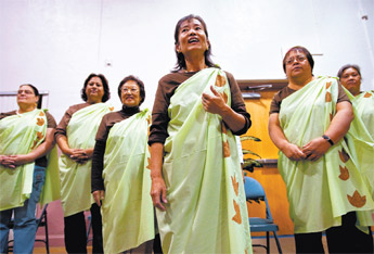 Kawahine Tokunaga, center, leads a group of traditional singers and storytellers that traveled to Gallup from Oahu, Hawaii, for the Hane’ Storyteller Festival at First United Methodist Church Friday. — © 2009 Gallup Independent / Cable Hoover 