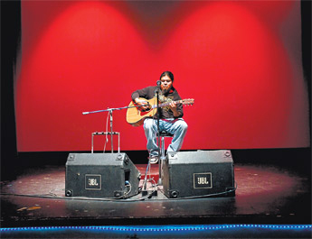 Local musician Loren Anthony performs some of his original work during an open mic event at El Morro Theatre Saturday. The theater will host the event every month during the downtown arts crawl according to production coordinator Knifewing Segura. — © 2009 Gallup Independent / Cable Hoover 
