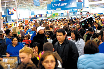 A crowd of holiday shoppers packs the entertainment and electronics section of Walmart at 5:23 Friday morning in Gallup. — © 2009 Gallup Independent / Cable Hoover 