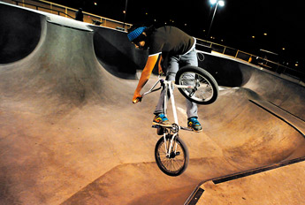 Billy Logg cathes air off the hip on Saturday night at the Tuba City skate park. — © 2009 Gallup Independent / Brian Leddy