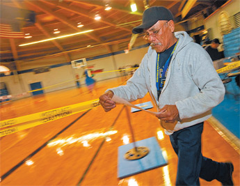 Fred Brown races around the basketball court at Window Rock Sports Center to post voter returns on Tuesday. — © 2009 Gallup Independent / Adron Gardner 