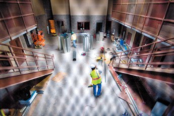 Workers are clouded behind a steel grid around cells under construction at the new juvenile detention center in Gallup on Thursday. — © 2009 Gallup Independent / Adron Gardner 