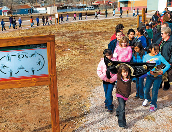 Students at Indian Hills Elementary walk along a path dedicated to Beulah Talayumptewa on Wednesday. Talayumptewa, who was a teacher at Indian Hills, was killed in August of this year by a DUI driver. — © 2009 Gallup Independent / Adron Gardner 