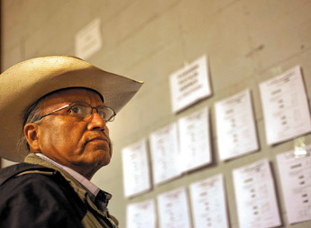 Clinton Jim looks over chapter house voter returns throughout the Navajo Nation for the special election at the Window Rock Sports Center on Dec. 15. — © 2009 Gallup Independent / Adron Gardner 