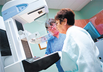 Mammography specialist Nikki Thompson, left, positions the new digital mammogram machine for Idy Guzman at Cibola General Hospital in Grants on Tuesday. — © 2010 Gallup Independent / Cable Hoover 